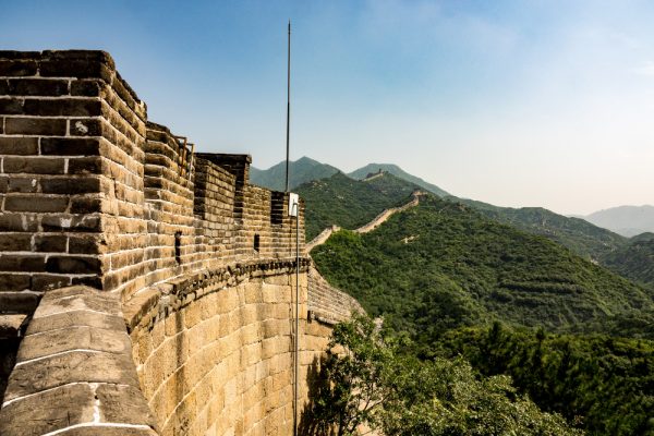 high-angle-closeup-shot-famous-great-wall-china-surrounded-by-green-trees-summer